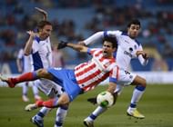 Atletico Madrid's Diego da Silva Costa (C) fights for the ball with Getafe's players, on December 12, 2012
